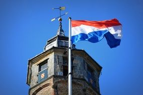 dutch flag on a stone tower