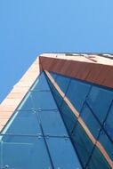 building with window facade in the light at blue sky background