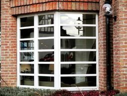 Stone facade with a mirror window