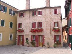 pink building with red flowers on the facade