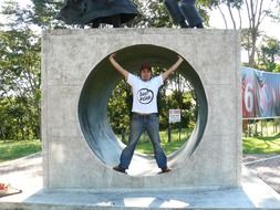 young man at stone monument round hole