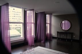 hallway interior with purple curtains and mirror