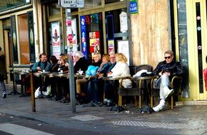 Photo of humans are sitting in corner cafe