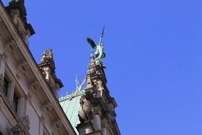 sculpture with wings on a historic building