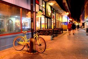 a bicycle stands near a restaurant