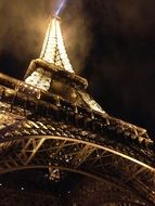 Eiffel Tower at night with a spotlight