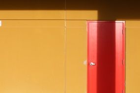 red doors on a yellow wal