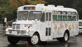 vintage painted isuzu bus in city