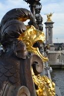 Photo of golden sculptures on a bridge