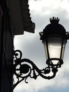 openwork street lamp on the facade of the building