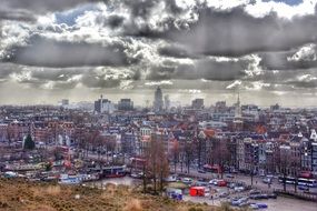 Historical center of amsterdam in the background of thunderclouds