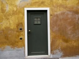 black door on an orange wall