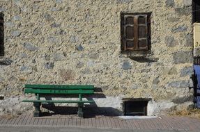 green bench near the old building