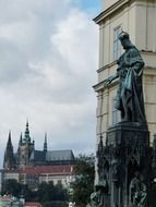 Statue near st vitus cathedral on the background of Prague