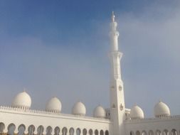 tall white minaret above domes, uae, abu dhabi