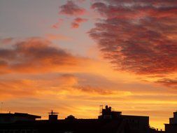 the roofs of the city at sunset