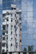 reflection of a building in a glass skyscraper