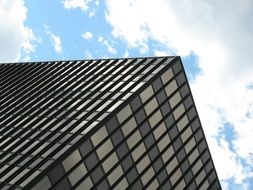 white clouds over a city skyscraper