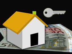 drawn house on euro banknotes and a house key