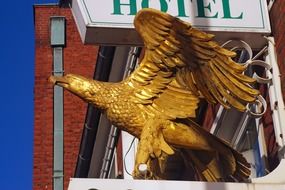 Gold eagle statue on a hotel sign
