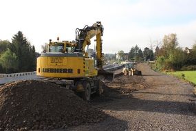 excavator digs the road