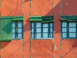 facade of the building with windows with green shutters