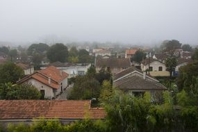 Architecture of old houses in town in the fog