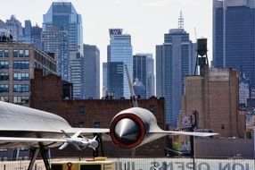 an aircraft carrier on the background of skyscrapers of Manhattan, New York city