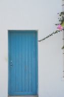 blue doors in a white house