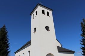 White building of the Catholic church with a tower