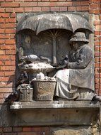 The stone sculpture of sitting humans