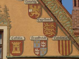 image of various coats of arms on the wall of the town hall