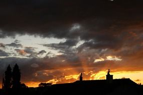 sunset over the roof of the house