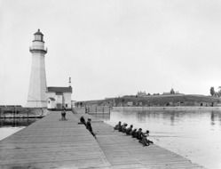 lighthouse on the pier in black and white background