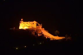 medieval castle on mountain at night