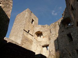 castle ruins with stonework at blue sky background