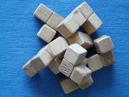 wooden cubes of the puzzle on a blue background