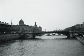 black and white photo bridge over the river in paris