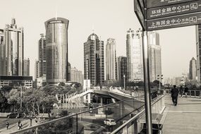 people on pedestrian bridge in downtown, china, shanghai