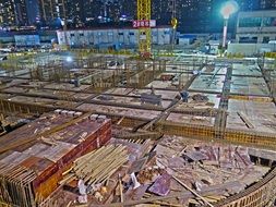 construction site of skyscraper in city at night, china, shanghai