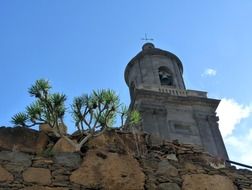 church with a bell on a rock