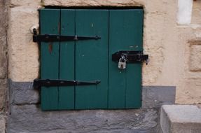 green wooden door in a stone building