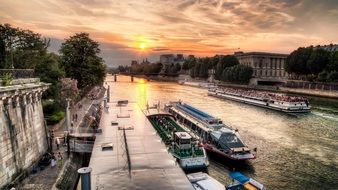 Boats on the seine river in Paris at sunset