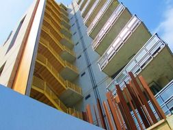 Construction facade with balconies and yellow staircases, usa, san diego