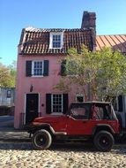 pink house on city street in america