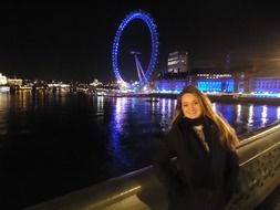 Woman in colorful London at night