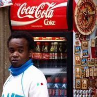 african man near the fridge with drinks