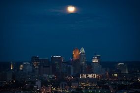 view of the night city under the moon