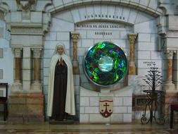 tomb with a precious stone and a sculpture of a woman