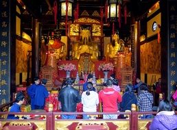 people at a ceremony in a city temple in shanghai